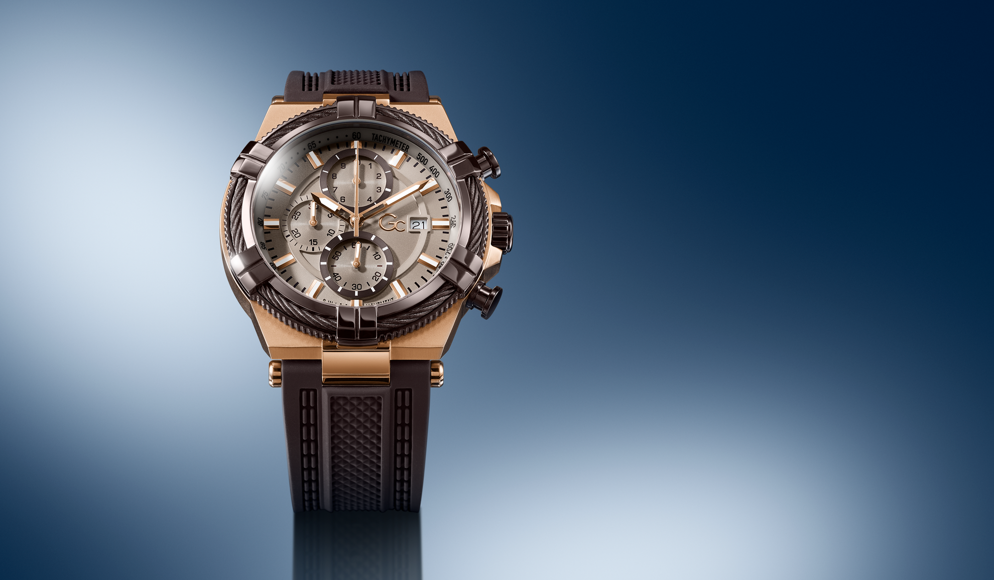 Gc IronForce Chrono Silicone watch with brown strap and detailed face on a gradient blue background