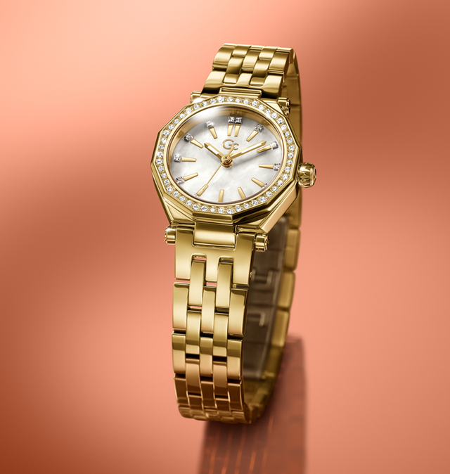 Gold wristwatch Z54005L9 with a diamond-studded face on a peach-colored background