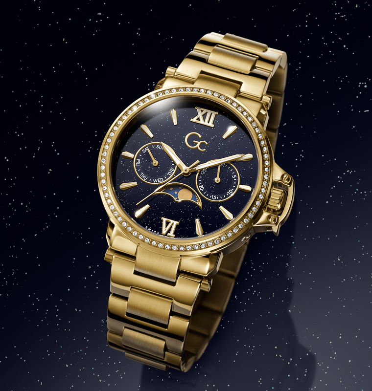 Gold Gc wristwatch with a dark face featuring Roman numerals on a starry night background