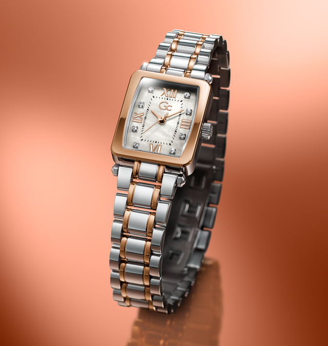 Womens Gc Plaza Mini two tone watch on orange background