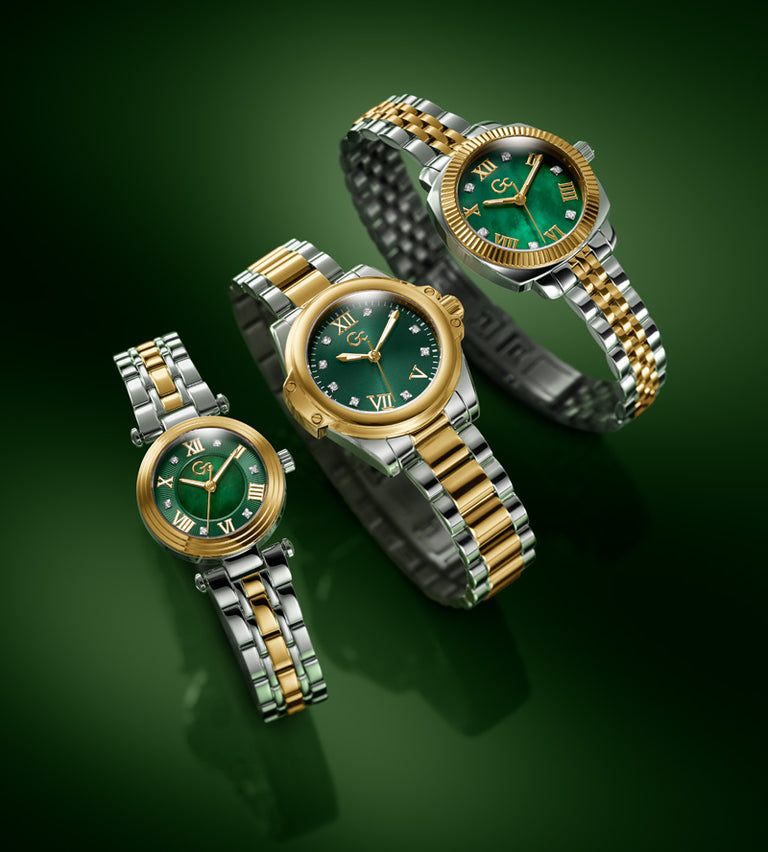 Three women's two-tone watches with green dials and gold-and-silver metal bracelets, arranged on a dark green gradient background.
