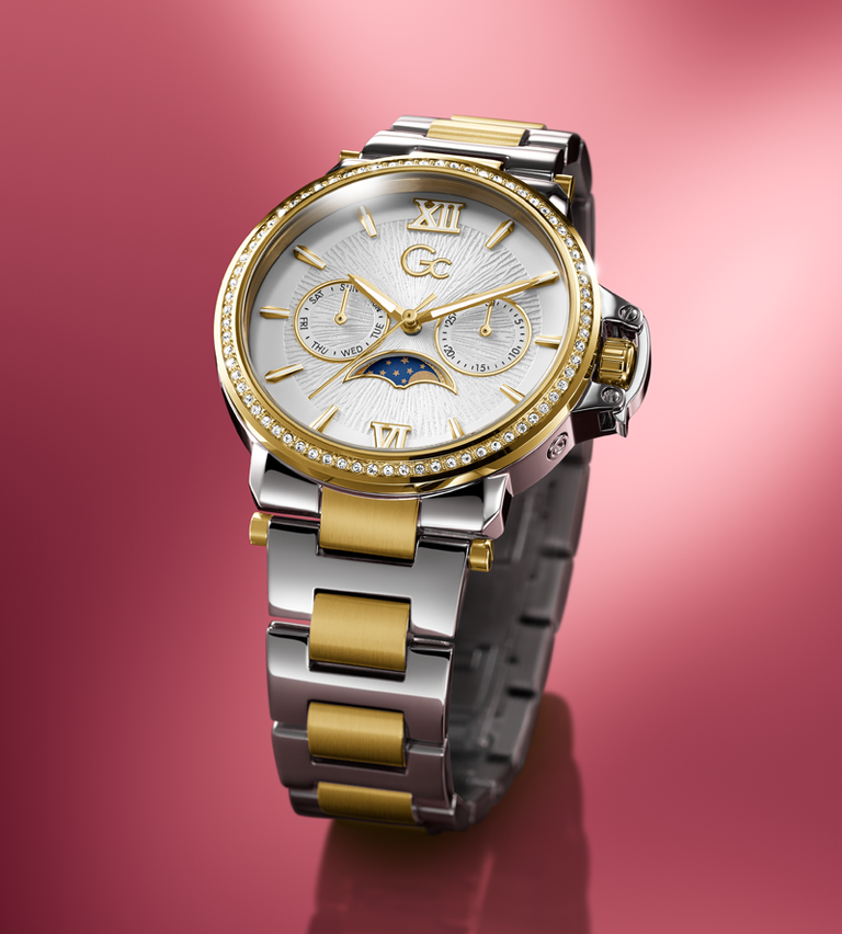 Gc Luxury watch with silver and gold band on a pink background