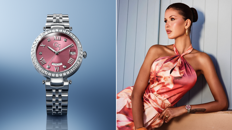 Gc Watch with pink face and silver case on a blue gradient background, next to a woman in a pink dress.