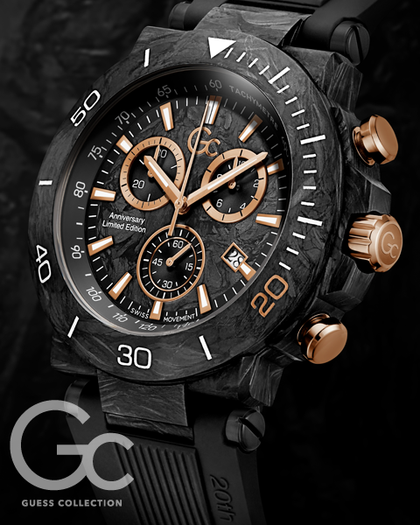 A close-up of a Guess Collection wristwatch with a black carbon-fiber-textured case and dial, accented by rose-gold-toned chronograph buttons and subdials, on a dark background.