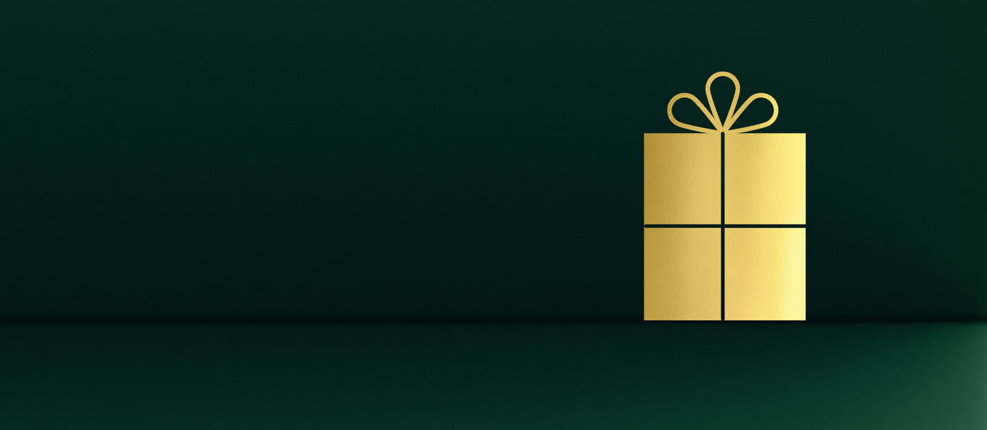 Gold gift box with a bow on a dark green background