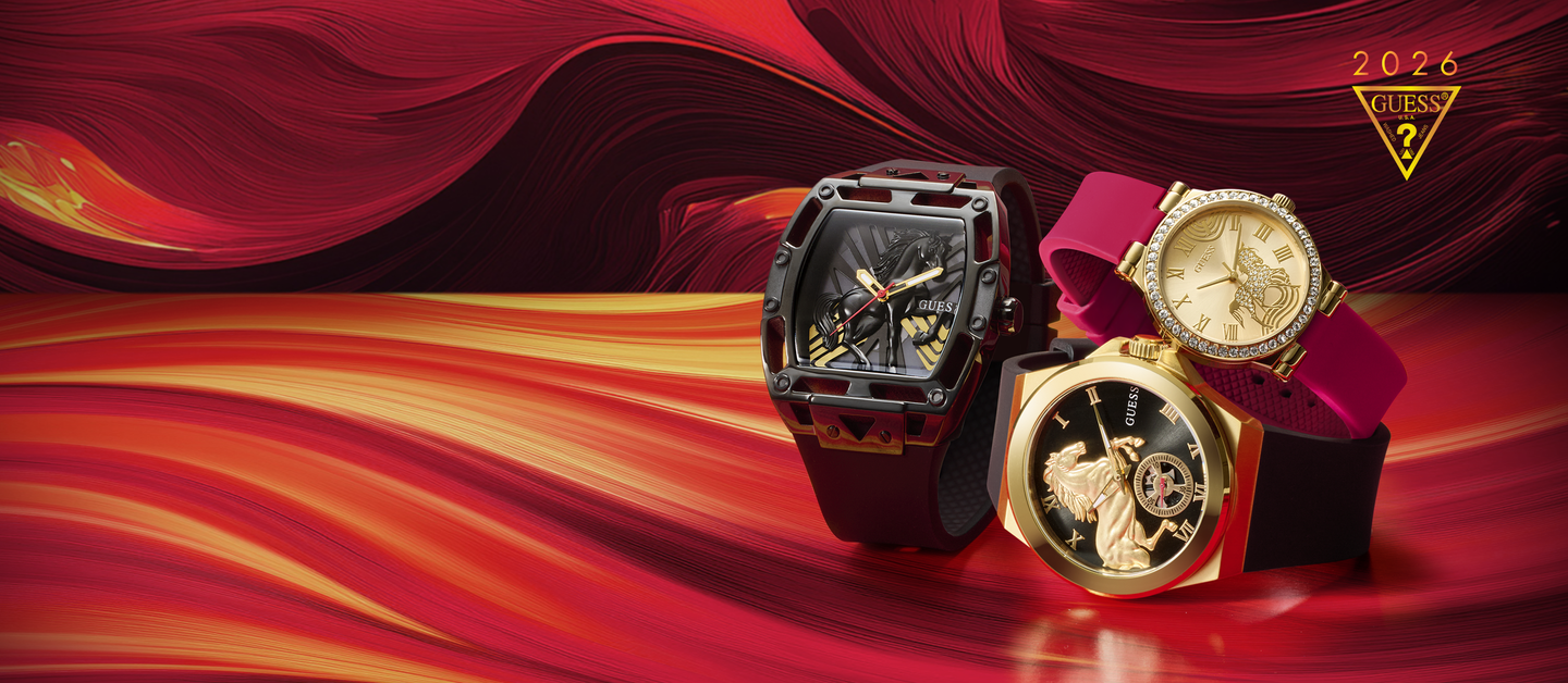 Three watches on a red and orange abstract background with gold Guess logo.