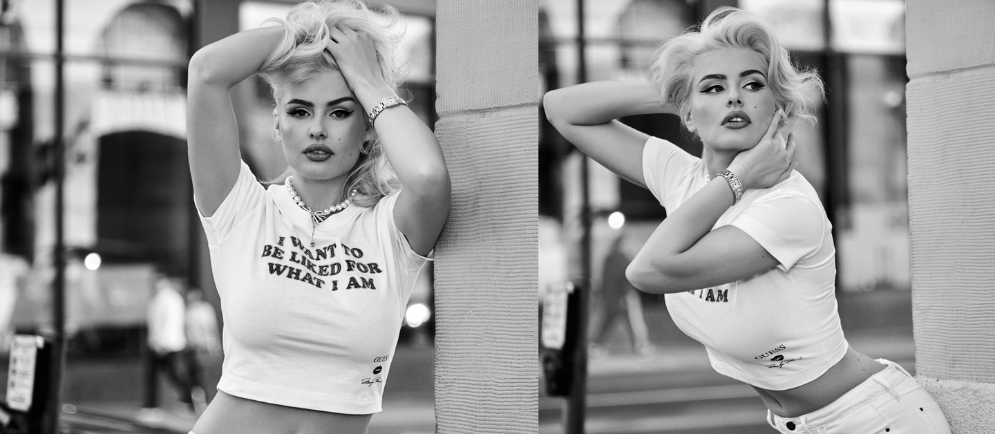 A black and white split-screen lifestyle photograph of a blonde woman posing outdoors next to a stone pillar, wearing a white graphic t-shirt with the text 'I WANT TO BE LIED FOR WHAT I AM'.