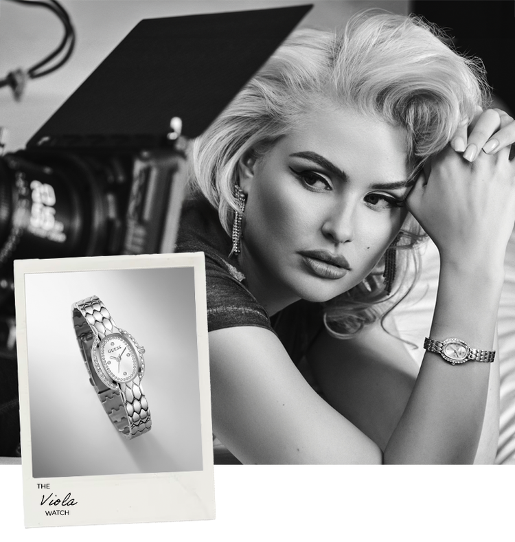 A silver-toned metal link bracelet watch is shown on a model's wrist in a black-and-white editorial portrait, with a smaller product inset in the lower left reading 'The Viola WATCH'. Because a person is present, this is classified as Lifestyle rather than Product/Packaging.