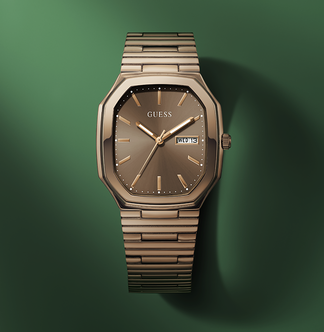 Guess watch with mocha metal strap on a green background