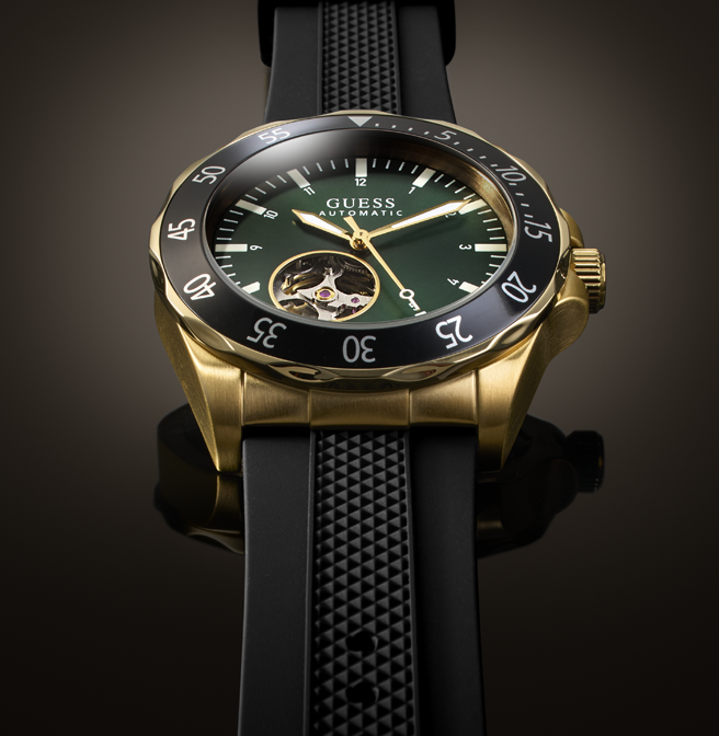 Mens gold and black automatic GUESS watch with green dial and silicone strap
