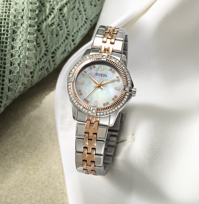 Silver and rose gold watch with a light face on a white surface