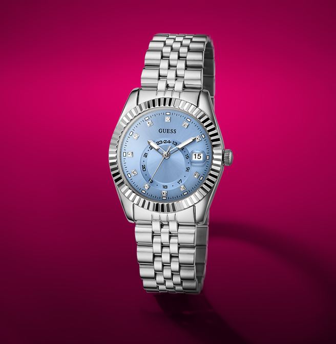 Silver watch with a blue face on a pink background
