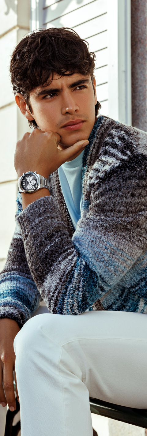 man in blue sweater wearing watch