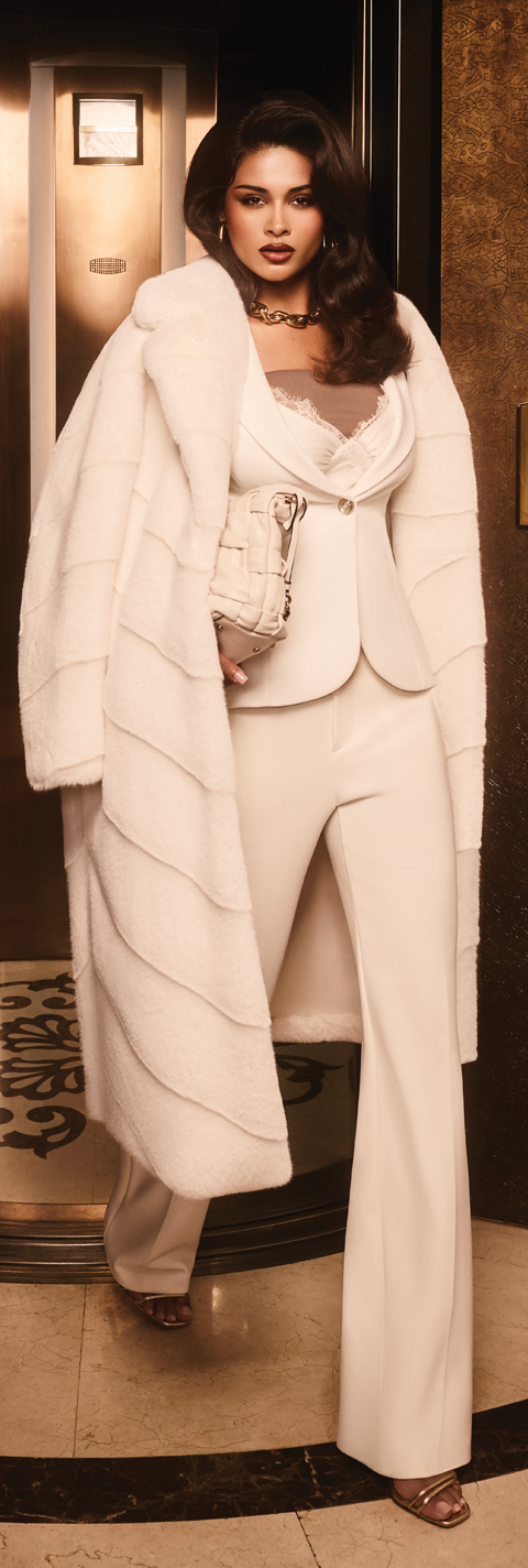 woman in white coat walking off elevator