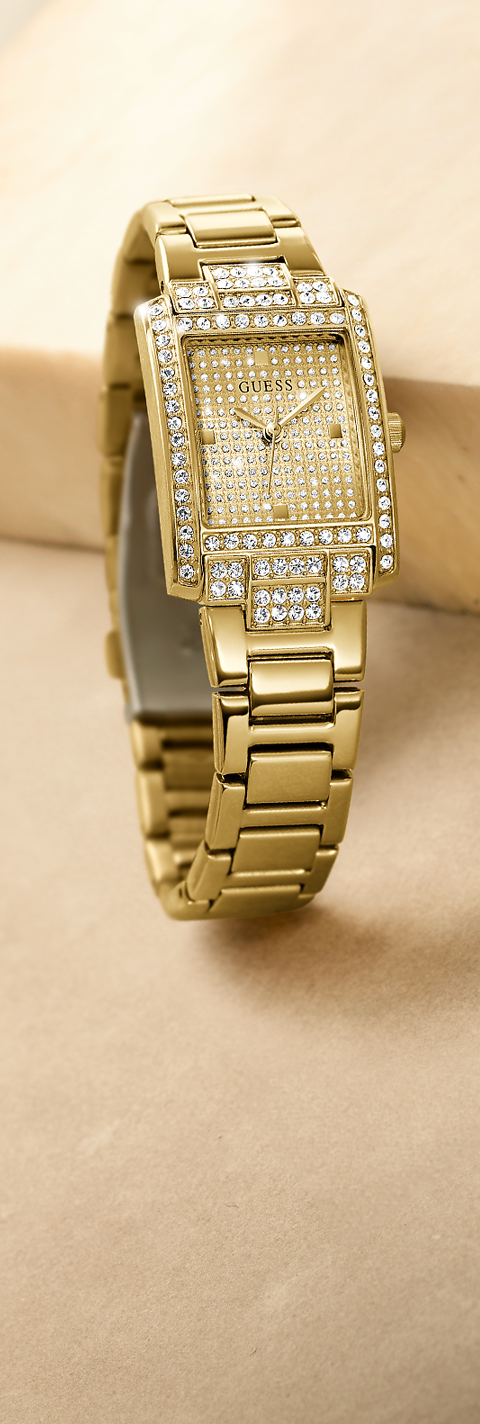 Gold wristwatch with diamond accents on a beige background