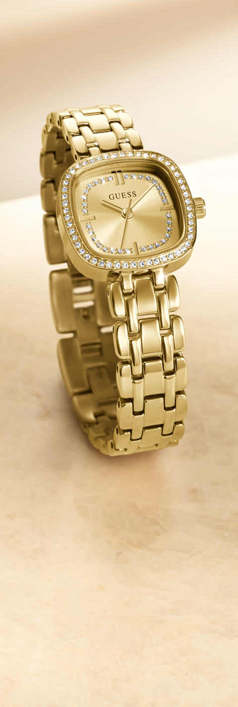 Gold watch with diamond-studded bezel on a beige background