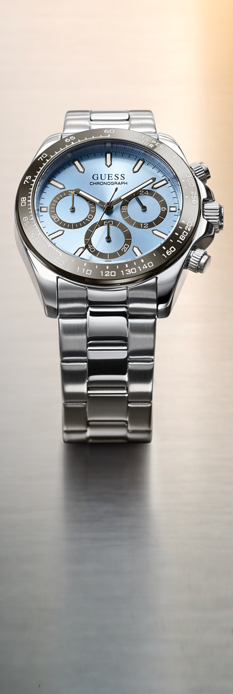 Silver Guess watch with a blue face on a gradient background