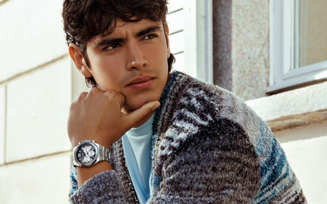 man in blue sweater wearing silver watch