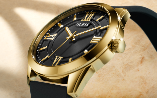 Gold watch with black face and black strap on a beige background