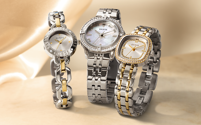 Three Guess watches with silver and gold bands on a beige background