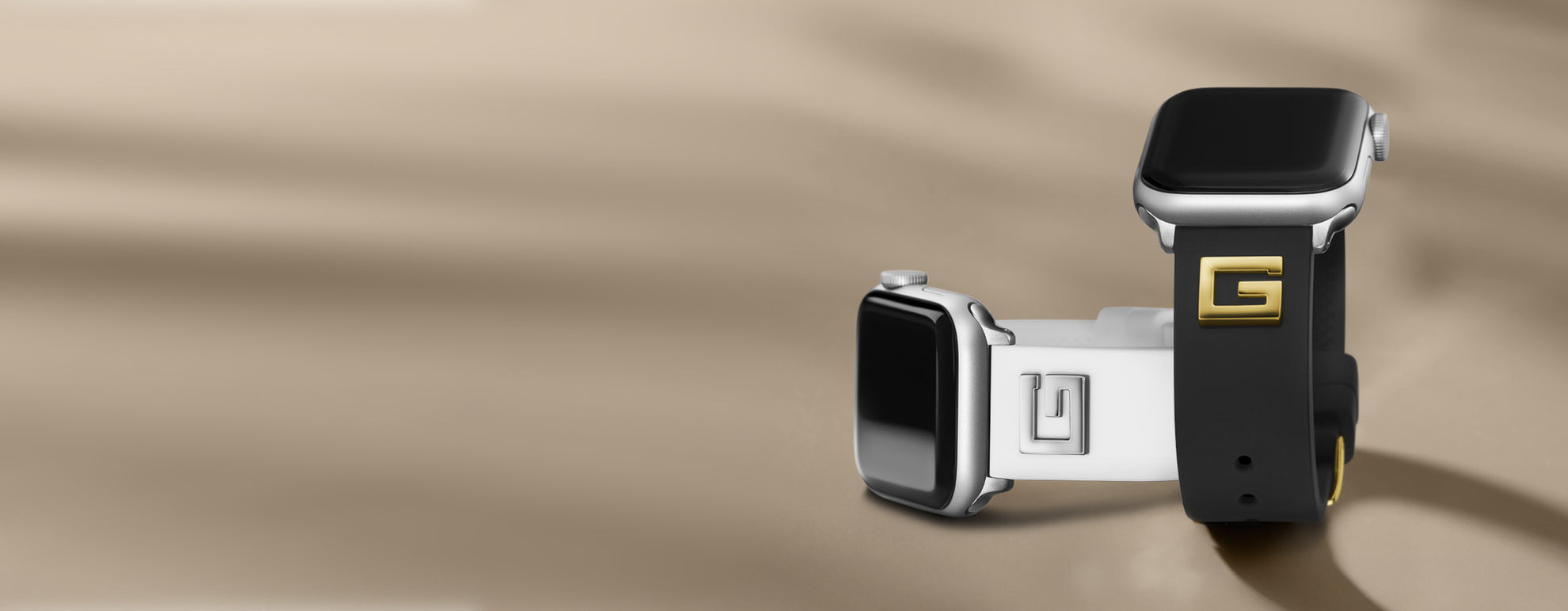 Two silicone Apple Bands with G logos on top of strap in black and white