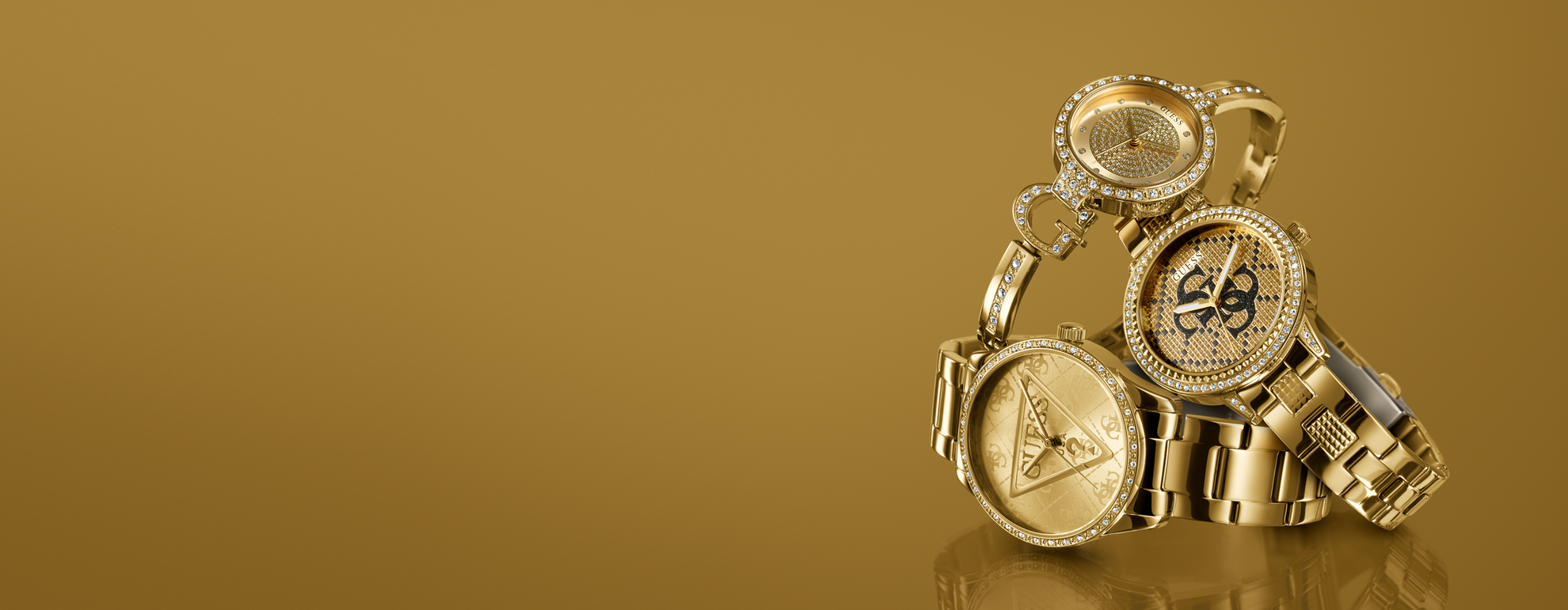 3 gold GUESS watches with logo designs on a gold background