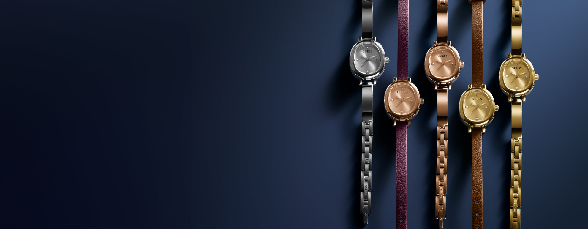 Row of gold wristwatches on a dark blue background