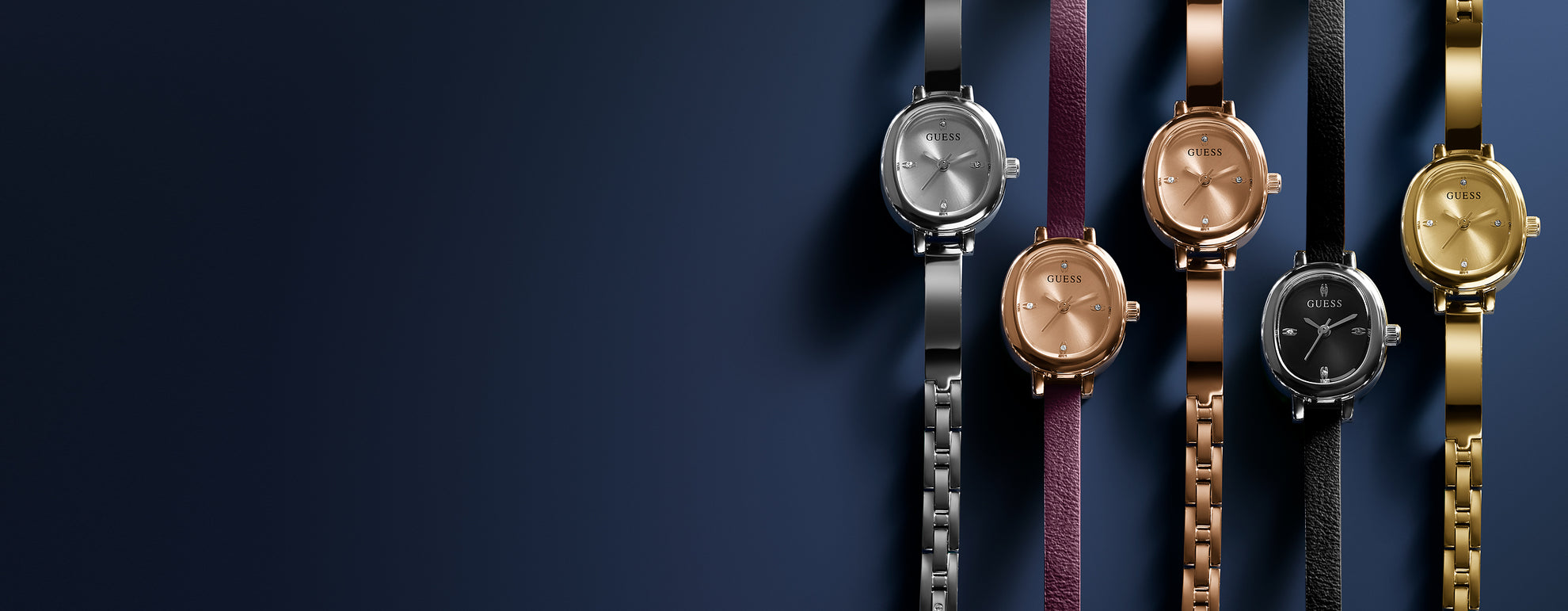 Five watches with different colored straps on a dark blue background