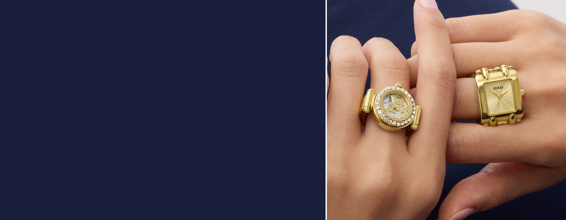 Two gold watch rings on a hand against a dark background
