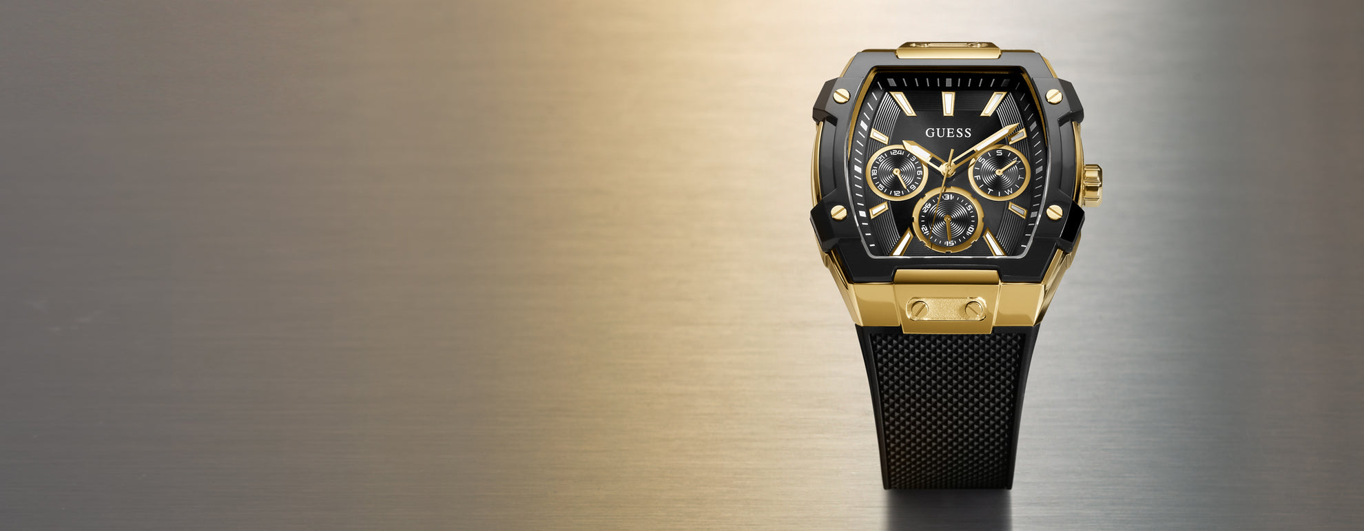 Gold and black watch on a gradient background