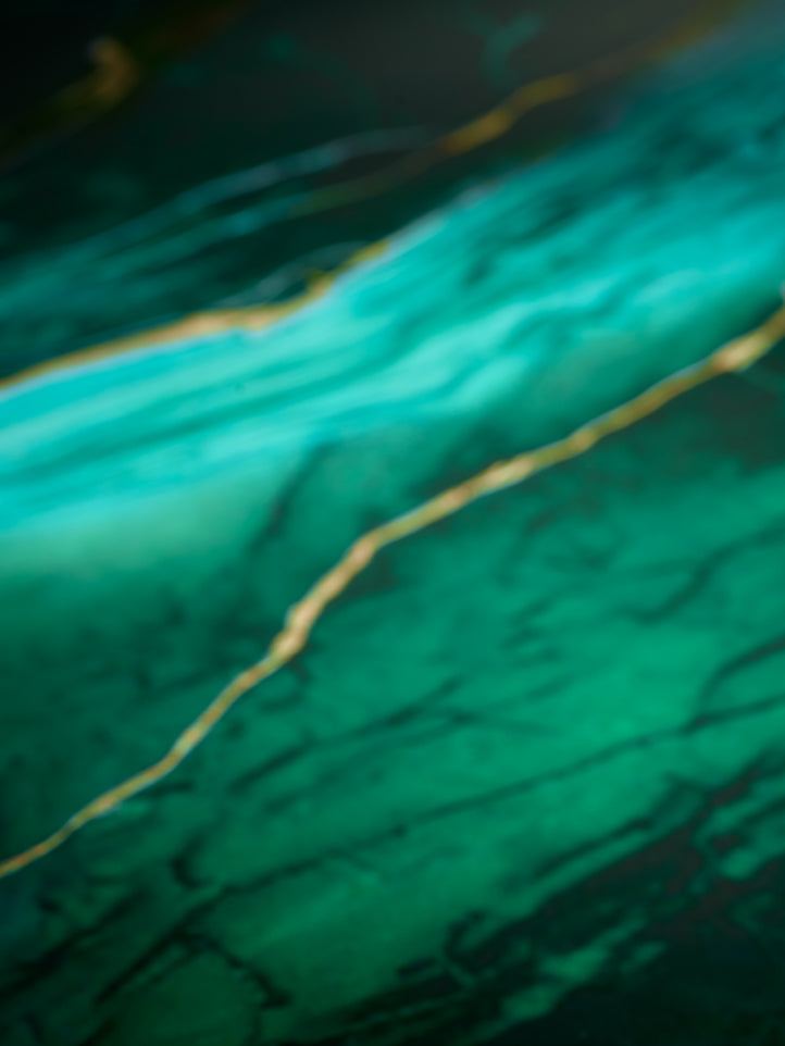 Close-up of a green marble surface with a gold line