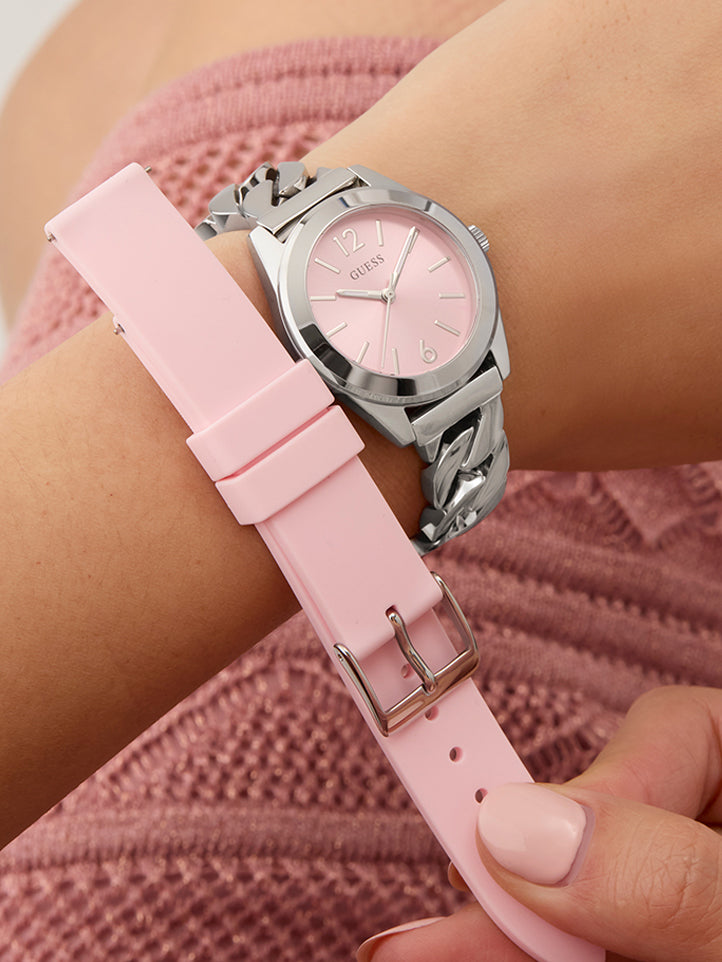 Womans wrist wearing silver watch with pink dial