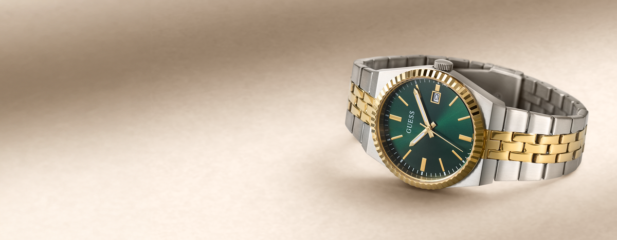 A two-tone stainless steel and gold wristwatch with a green dial, positioned on the right side of a warm beige gradient background.