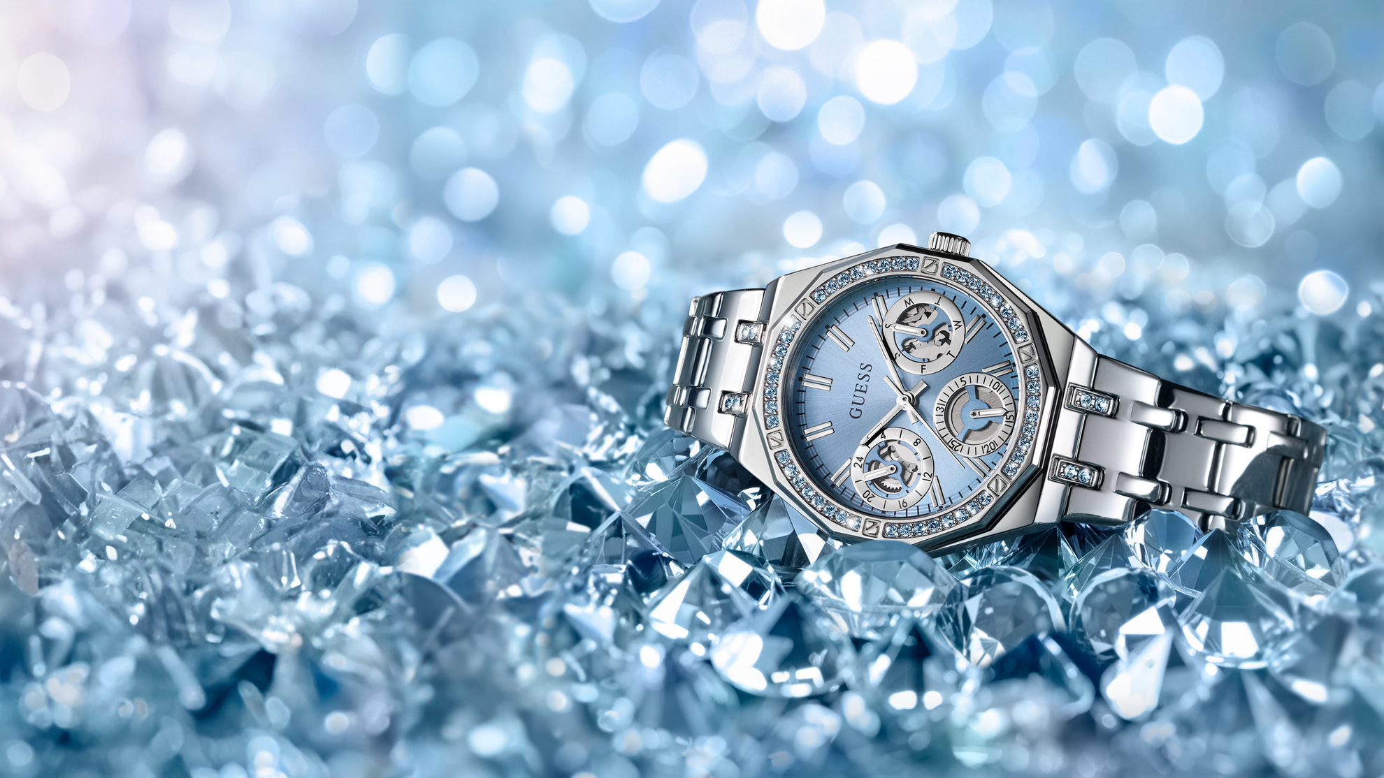 Silver watch with a blue face on a blue textured background
