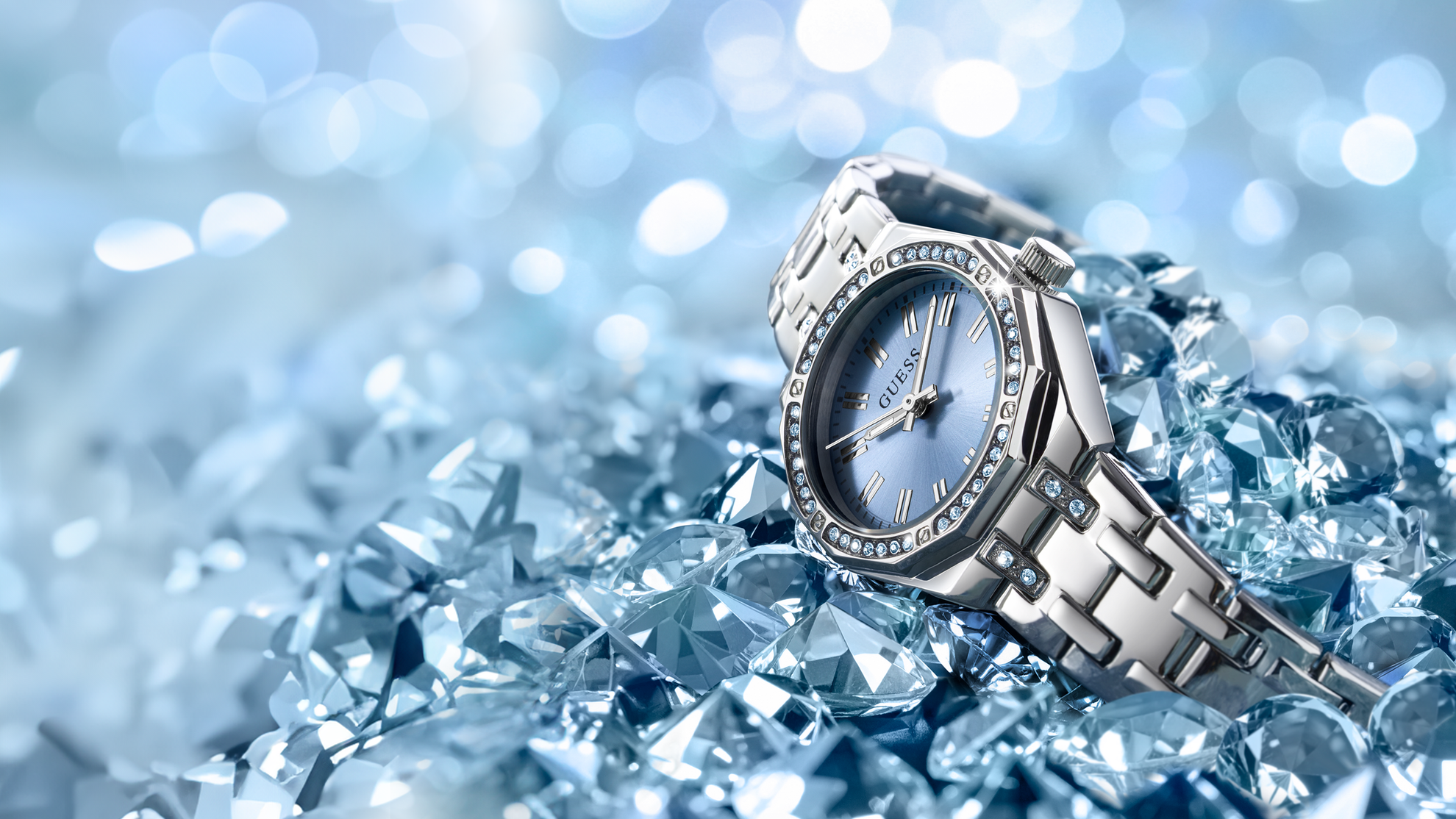 Silver Swarovski watch with gemstone face on a bed of ice crystals