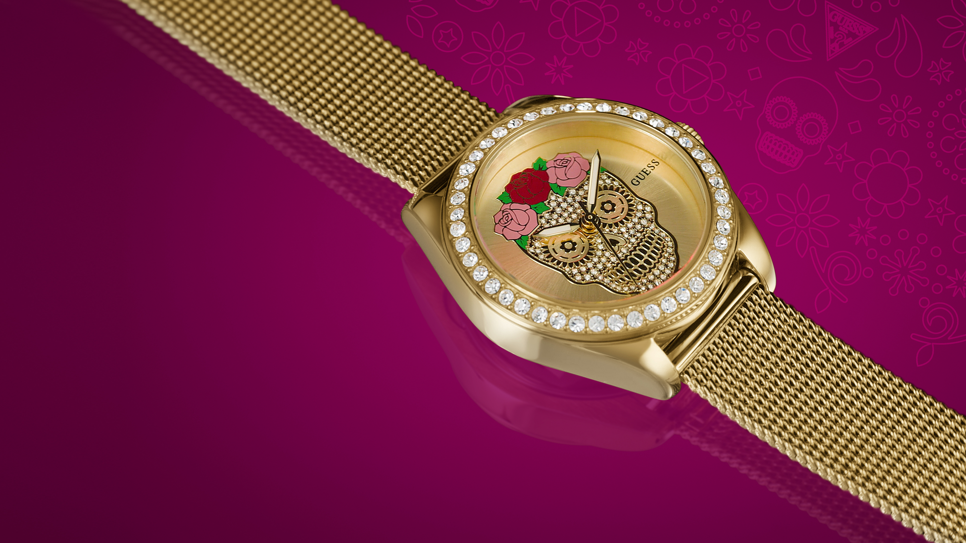 GW0946L1 Gold watch with decorative face on a pink background