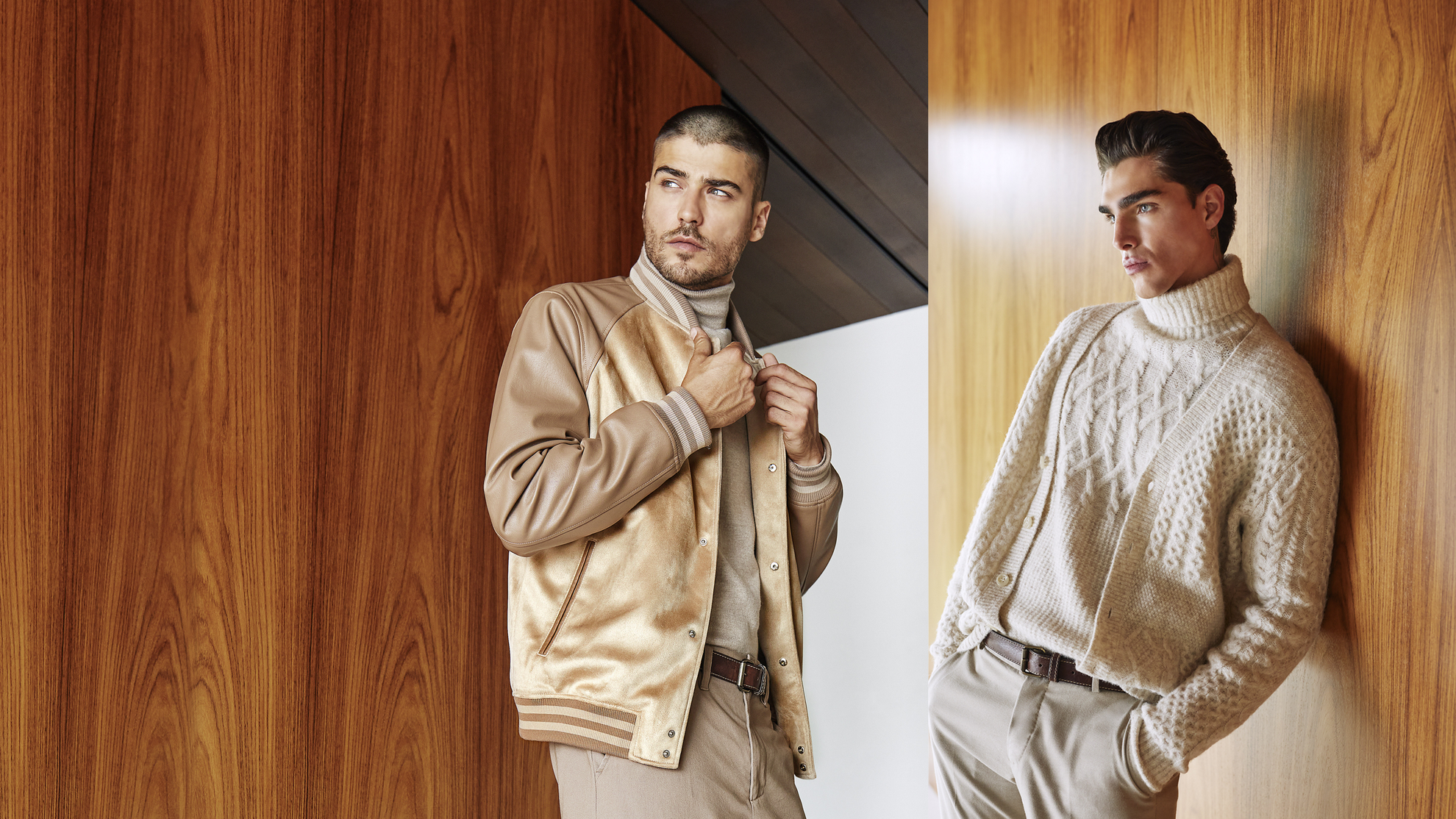 two men in tan outfits standing by wood wall