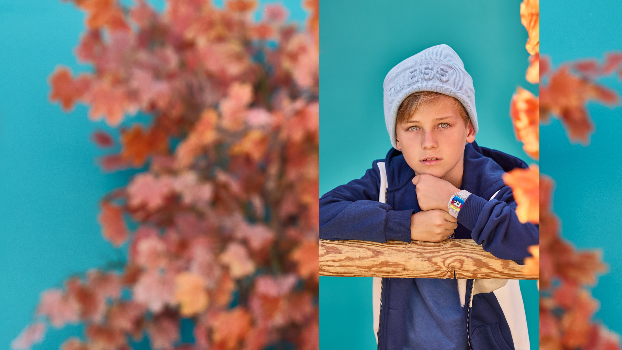 young boy in fall outfit wearing colorful guess watch