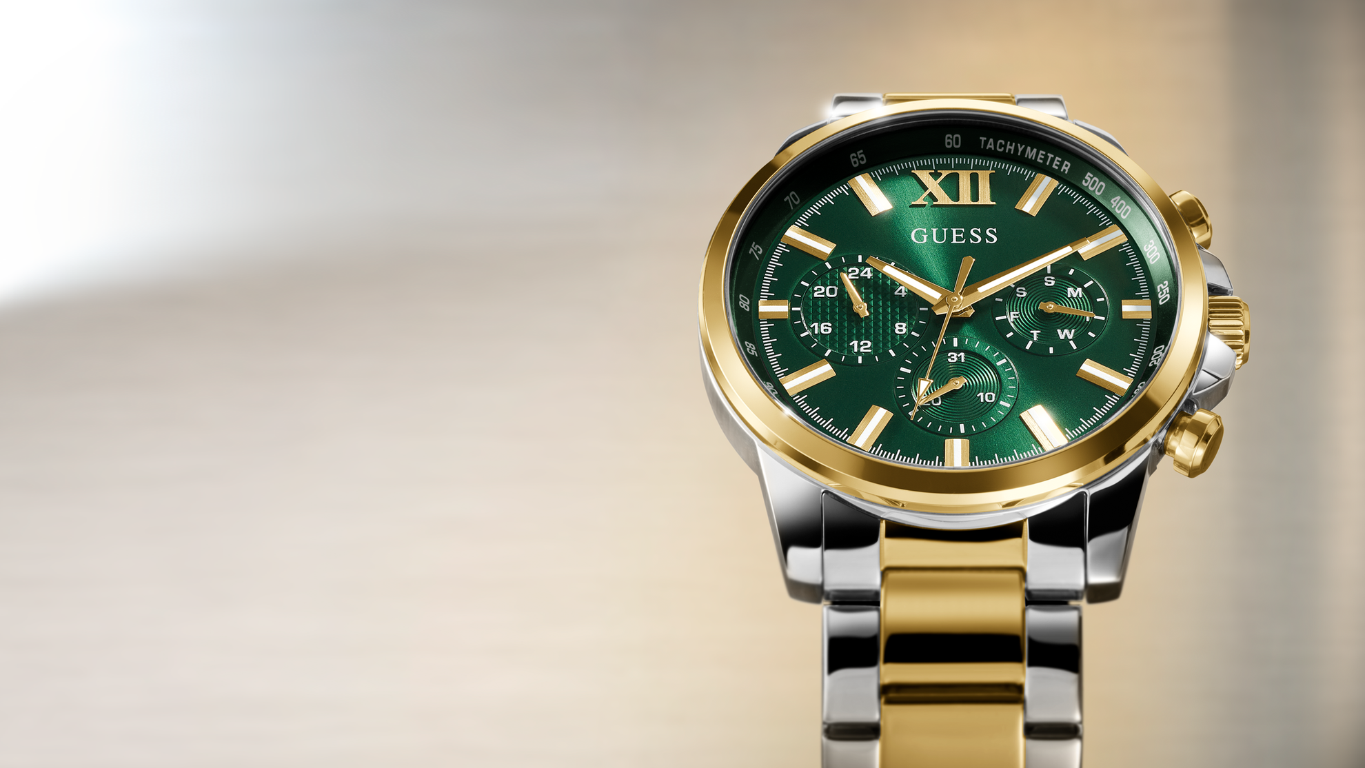 Gold and silver watch GW0900G5 with green face on a gradient background