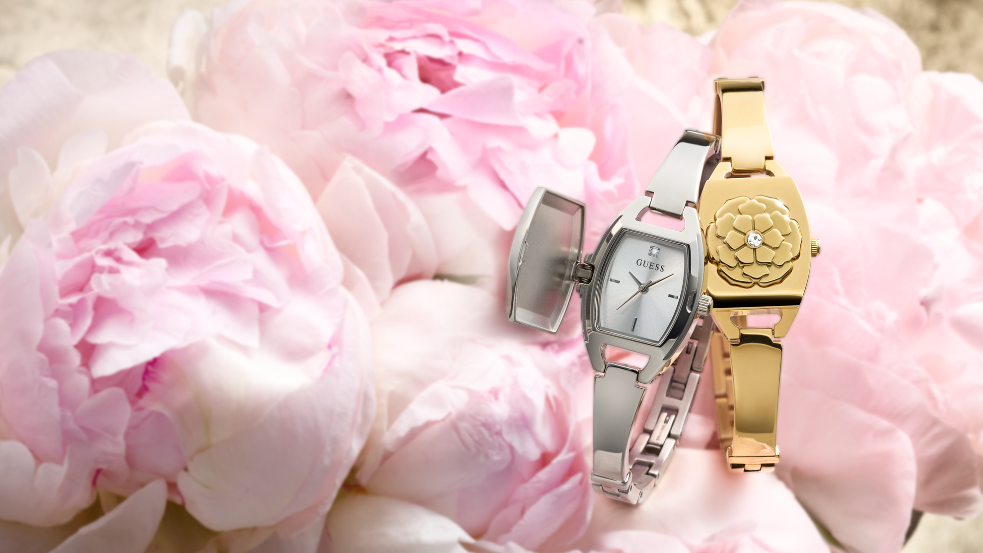 Two watches, one gold and one silver, on pink peony flowers