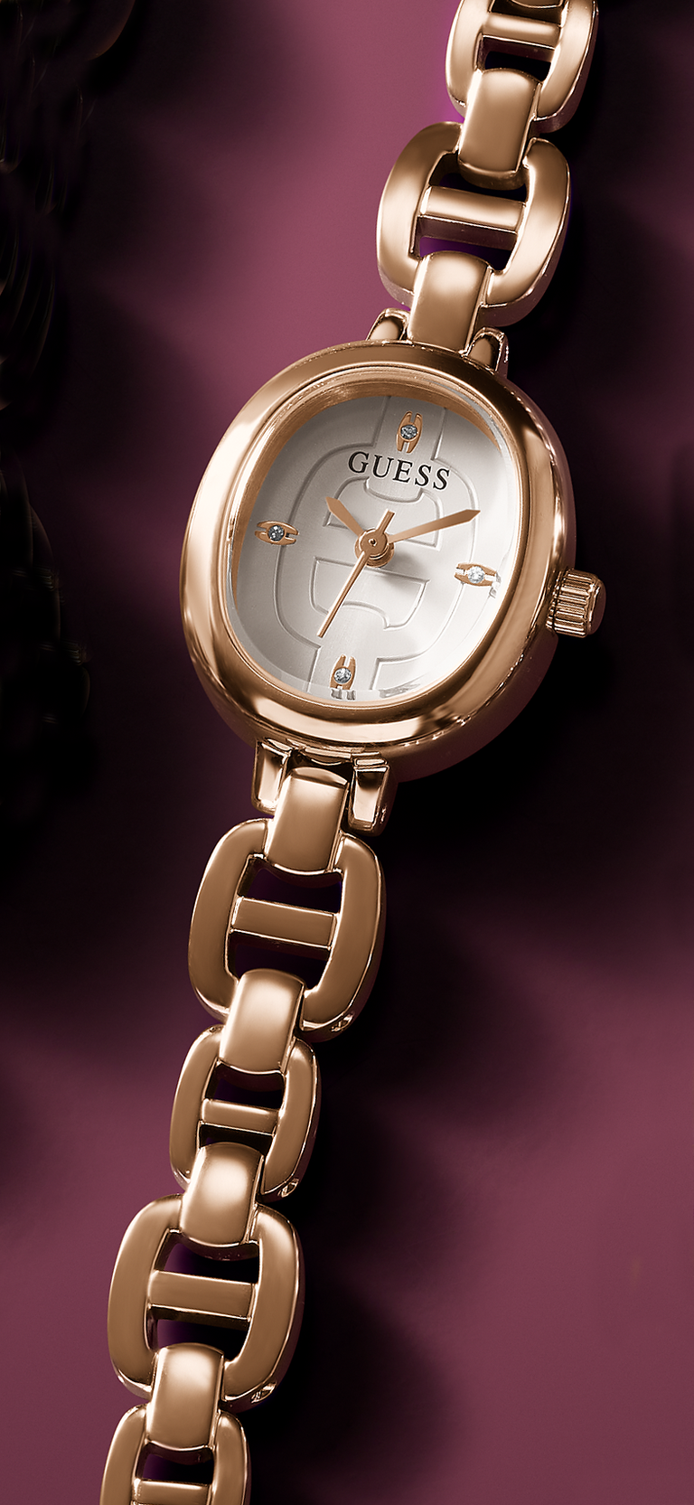 Rose Gold Guess watch on a dark purple background