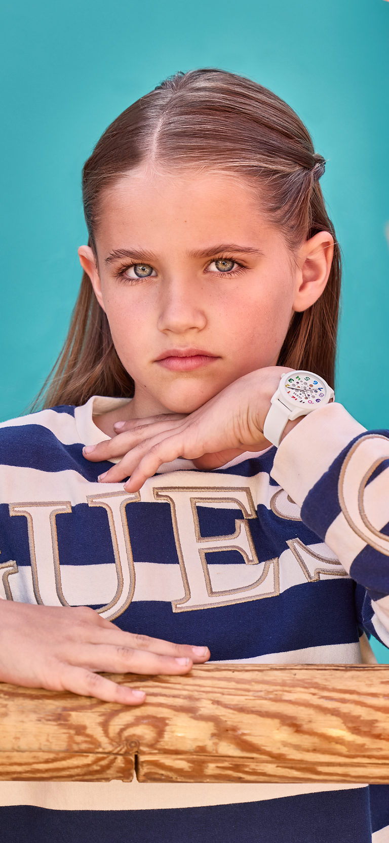 young girl wearing a white guess watch