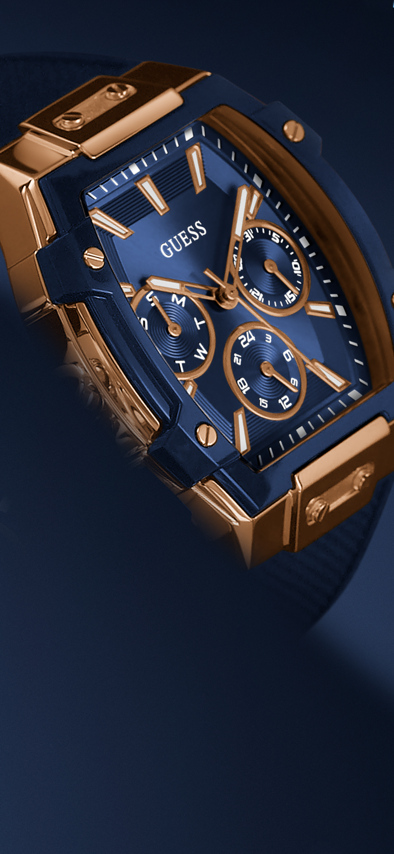 Blue and gold Guess watch on a dark blue background
