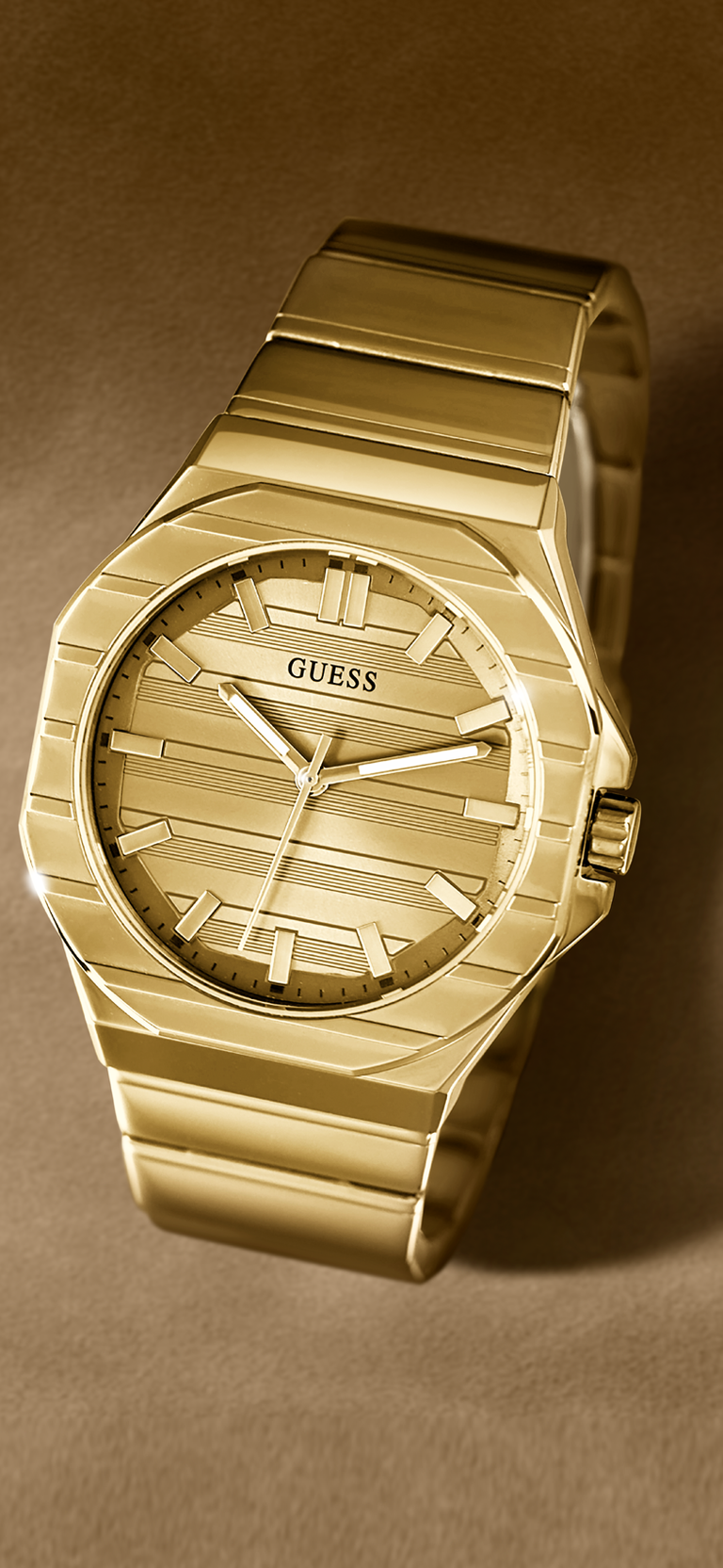 Gold watch with 'Guess' branding on a brown background GW1070G2