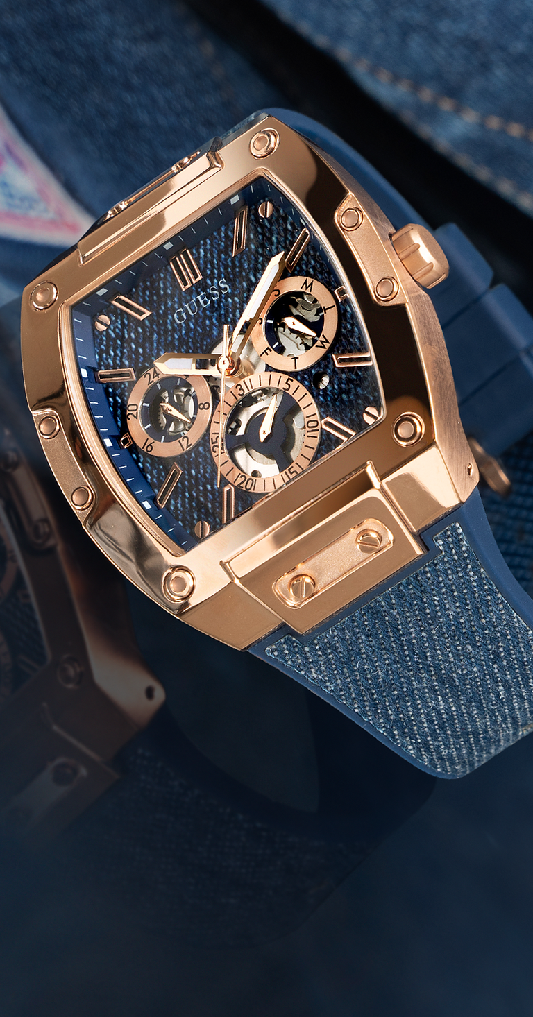 Luxury watch with rose gold case and blue strap on a dark background gw0203g10