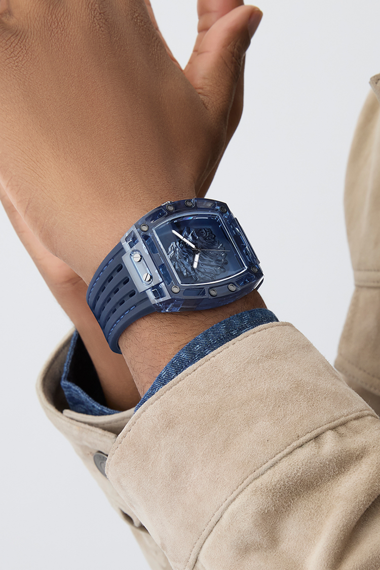 Blue watch on a wrist with a neutral background