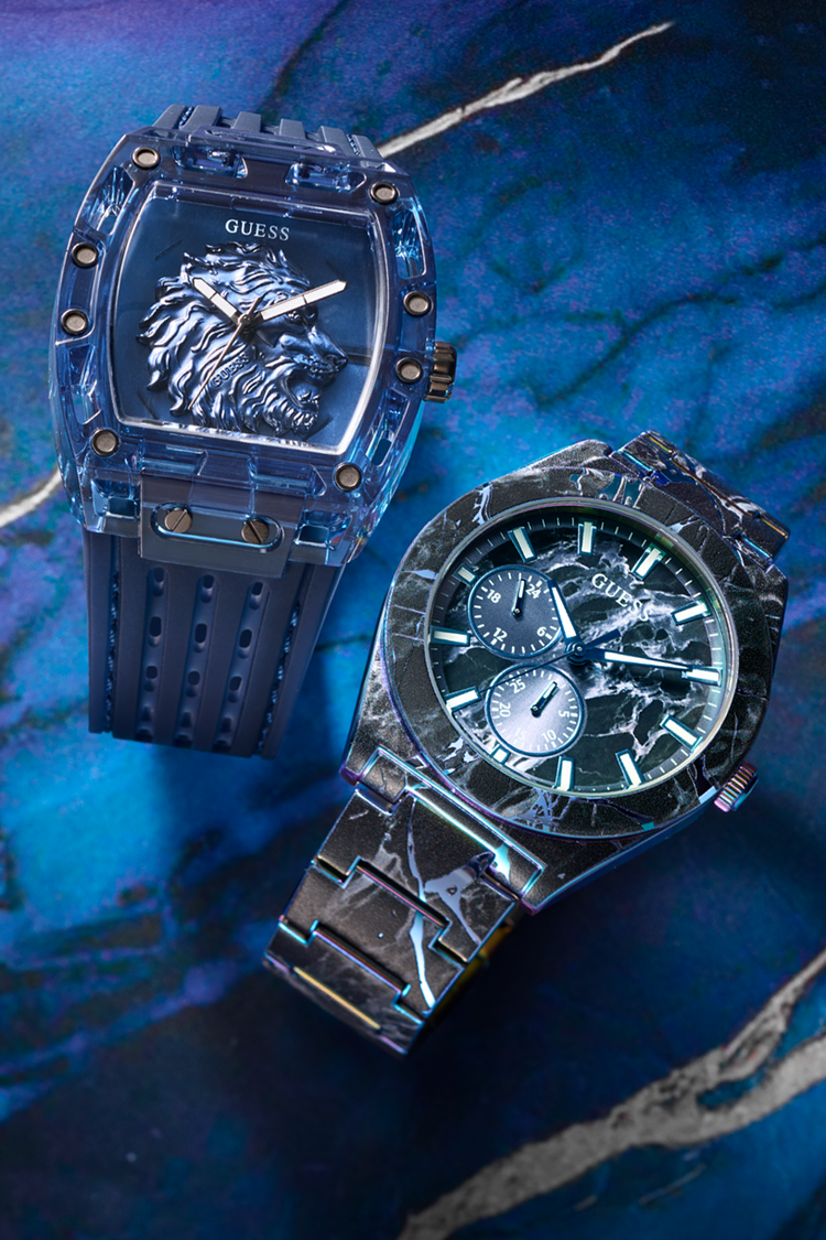 Two watches on a blue textured surface