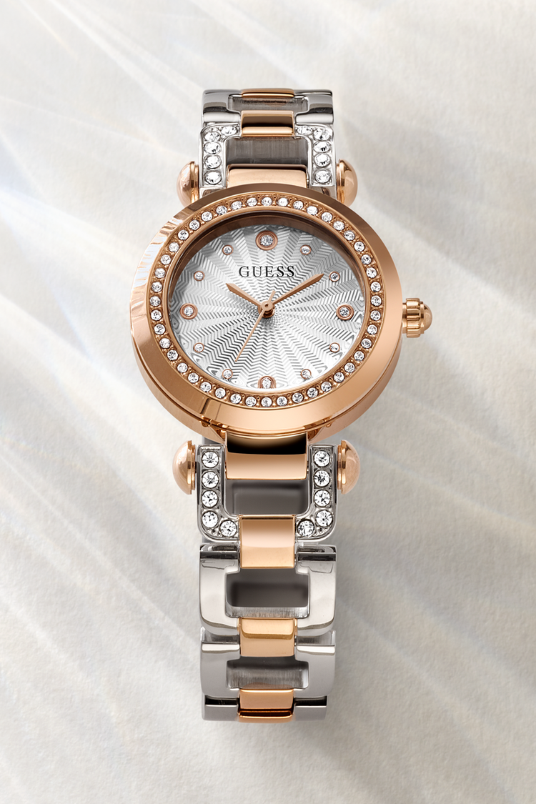 Two-tone Guess watch with rose gold and silver band on a light background