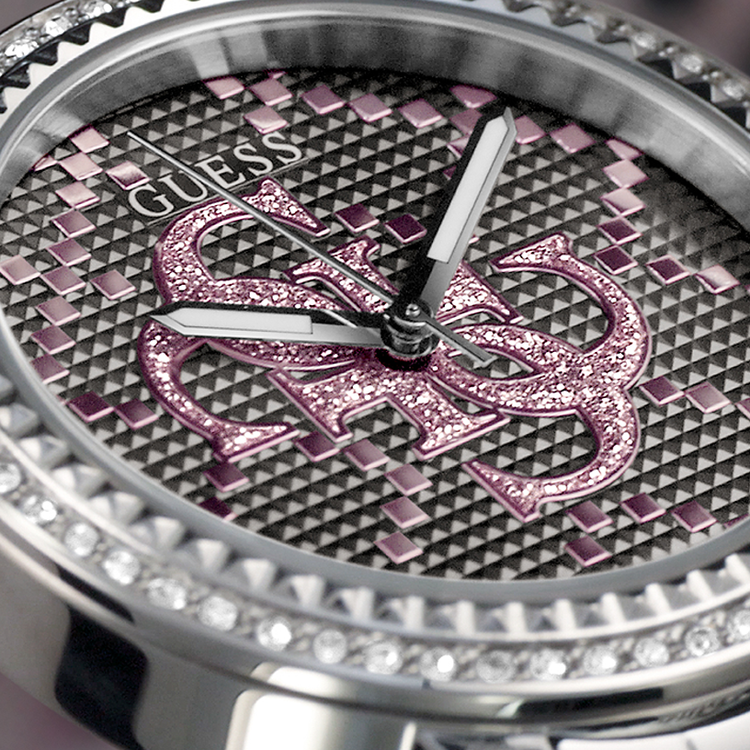 Close-up of a Guess watch with pink and silver design on a black background