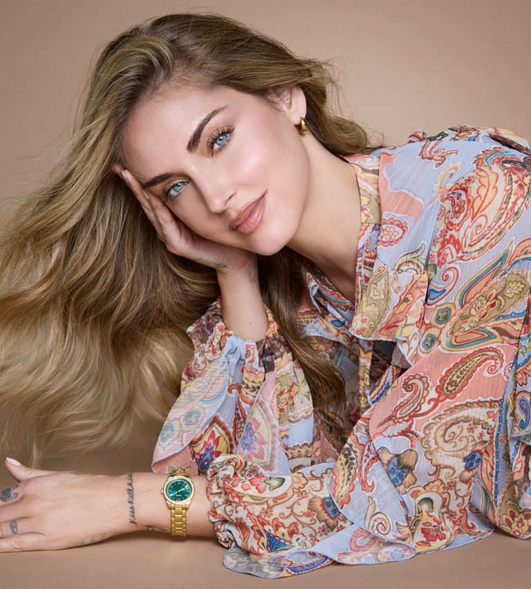woman wearing gold watch with green dial